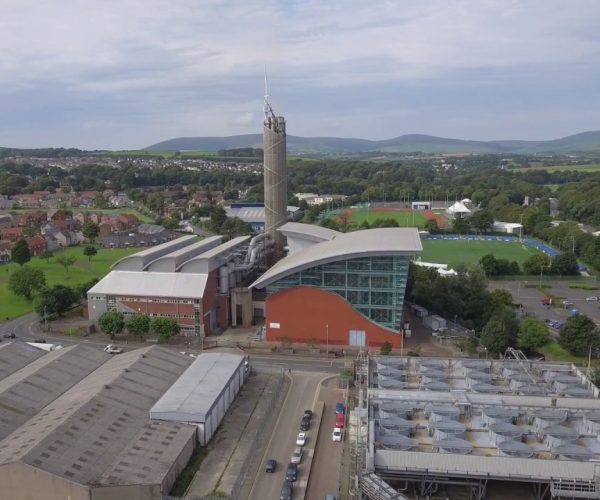 Case studies example aerial photo of Pulrose power station with residential area on the right and countryside and hills in the background